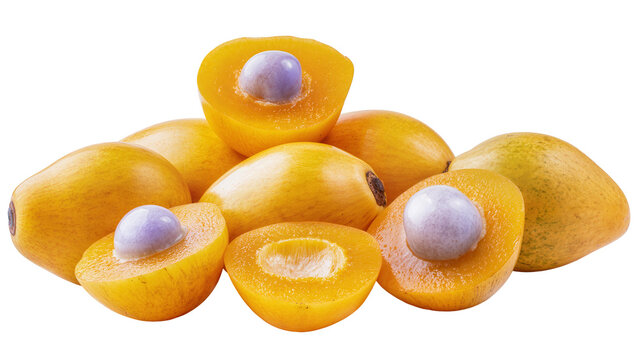 Isolated pile of ripe yellow canistel fruits, some whole and others cut open revealing light purple seeds