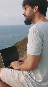 vertical Remote worker dreaming of adventure while using a laptop