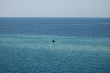 Fototapeta premium Jet Ski Riding Across Calm Turquoise Sea with Copy Space