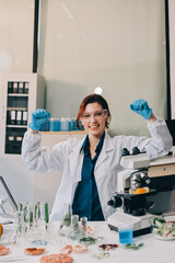 Fototapeta premium Scientists in lab coats work with plants in a modern lab, focusing on research and experimentation under bright, sterile conditions.