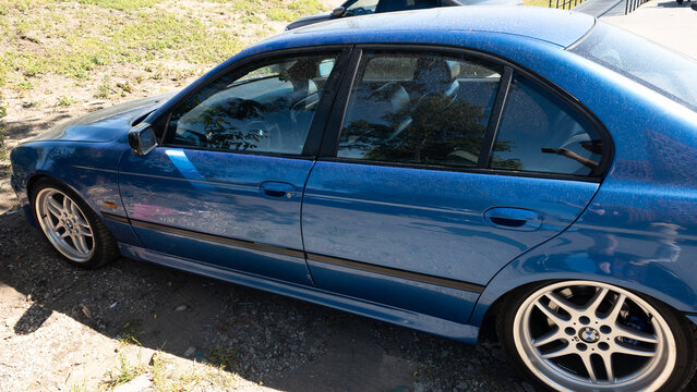 BMW 5 Series E39 blue sedan with classic German design, original body lines and alloy wheels showing iconic automotive style and vehicle history
