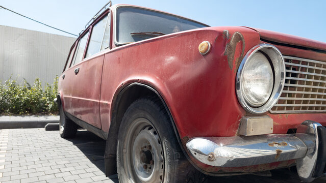 VAZ 2101 Lada classic Soviet car with red body, round headlight and chrome details showing vintage automobile design and automotive history