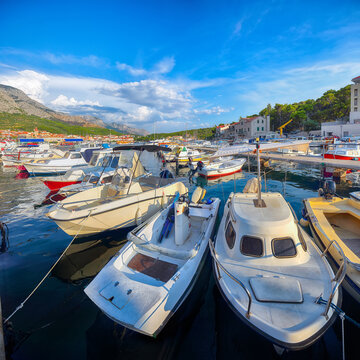 Amazing Adriatic resort Makarska with picturesque harbor and touristic boats.