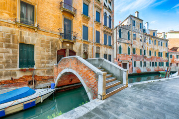 Amazing  cityscape of Venice with narrow canals, boats and gondolas and bridges with traditional buildings. © pilat666