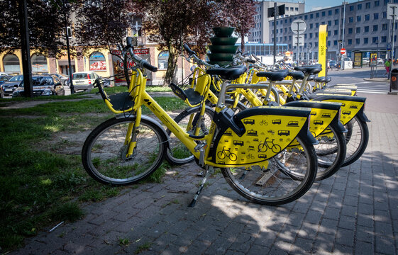 Katowice, Poland - 04 May 2024: Yellow Metrorower public bicycles at Saint Andrew Square, part of the Transport GZM urban mobility system.