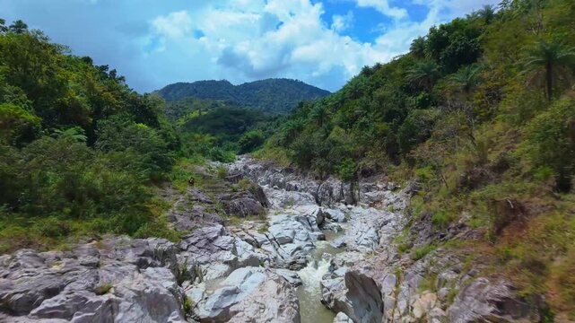 Drone orthomosaic-style view looking directly down at a girl in a bikini resting on the white river stones of Ca&ntilde;&oacute;n Blanco.