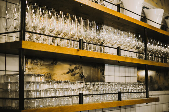 Glasses on the shelf in a bar or a restaurant.