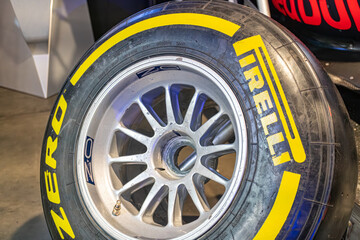 Obraz premium A single, out-of-focus image of a racing tire, branded as Pirelli with a yellow and black color scheme High-performance tread pattern visible - Kyiv, Ukraine - June 8, 2025