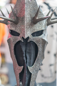 Gray and black, highly detailed Sauron mask with spikes, intricate eye sockets, hint of orange glow Metallic texture, blurred background - Kyiv, Ukraine - June 7, 2025