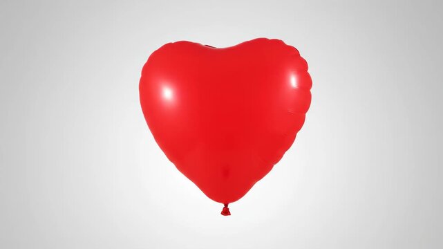 Vibrant red heart-shaped balloon floating isolated on a bright white background, symbolizing love, romance, Valentine's Day, and celebration.