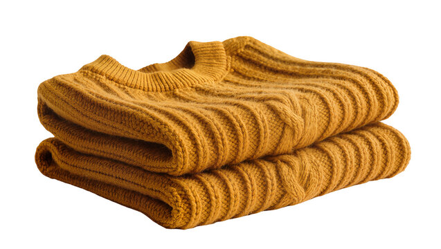 Isolated Two neatly folded mustard yellow chunky knit sweaters, warm and cozy winter fashion.