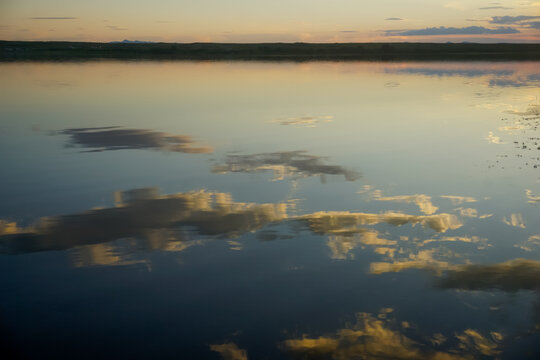 Blurred reflection of clouds in a salt lake in Tuva