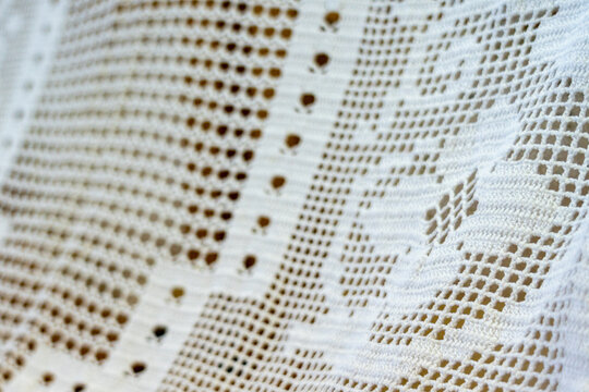 Hand-woven vintage cotton lace tablecloth featuring a detailed floral pattern.