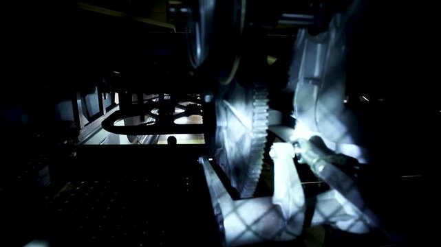 Inside of a bowling center machine. Pins rolling around and machine parts working