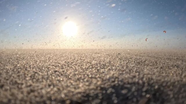 Windswept sunset at Kijkduin Beach featuring distant kiteboarding and glowing North Sea skies