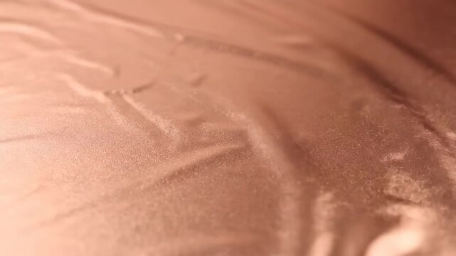 Abstract Speckled Rose Gold Metallic Surface Texture Background with Shallow Depth of Field