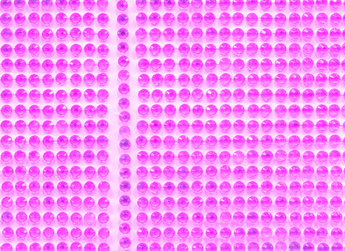 Pink faceted gems arranged in an even grid pattern, providing a vibrant decorative background