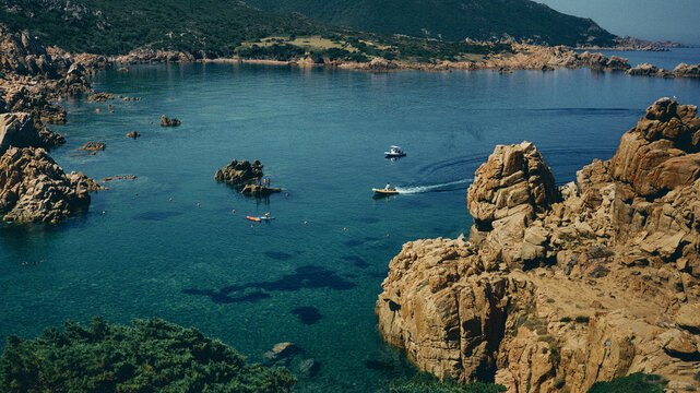 boats and the crystal clear waters of sardinia's coastline