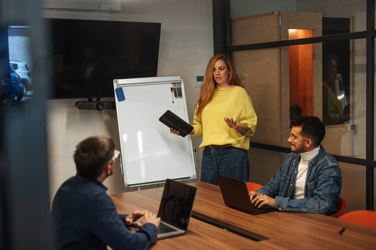 Woman presenting business ideas to attentive colleagues