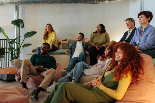 Diverse business team collaborating and bonding in lounge