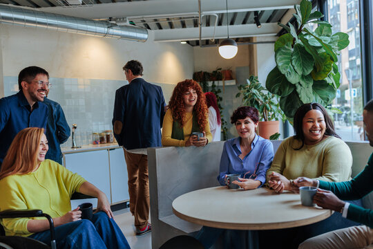 Diverse business team collaborating and laughing in office