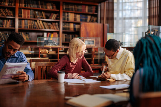 Diverse students studying collaborating in university library