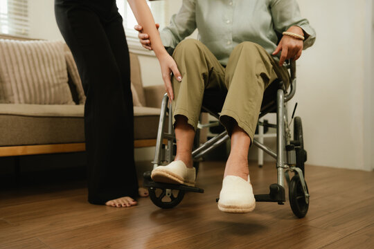 Caregiver assisting a senior in a wheelchair at home, providing mobility support, comfort, and compassionate elderly home care.