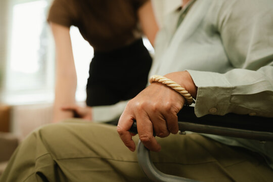 Caregiver assisting a senior in a wheelchair at home, providing mobility support, comfort, and compassionate elderly home care.