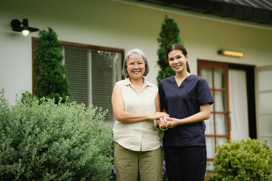 Professional caregiver assisting a senior woman during an outdoor walk, promoting mobility, balance, confidence, and independent aging.