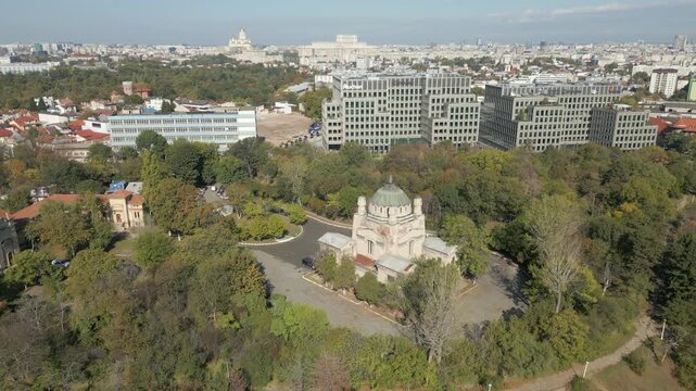 Cenusa Crematorium In The Park Surrounded By Trees Bucharest City Romania Drone Track Back 4K 60FPS