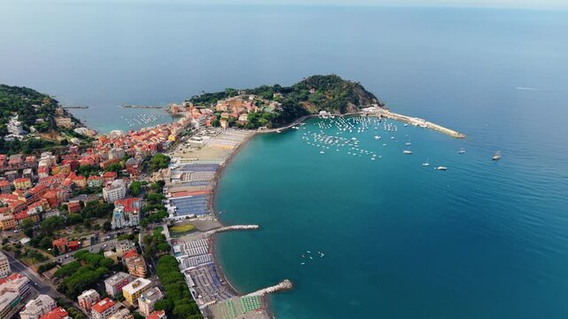 Colorful umbrella rows line the beach as boats fill Sestri Levante's bay.