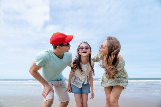 A joyful family enjoys a heartfelt moment together by the ocean expressing love trust parenting happiness and quality time during a relaxing seaside holiday.
