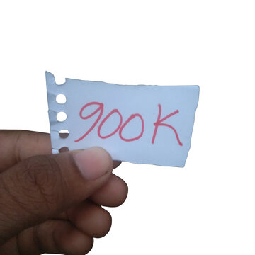 Hand holding a small torn piece of paper with 900k written in red ink isolated on transparent background
