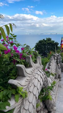 Da nang, lady buddha, dragon statue railing leading to linh ung pagoda, overlooking da nang city, ocean, and clouds from son tra peninsula