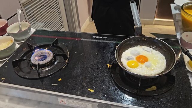 eggs in a frying pan with modena stove in Bandung, West  Java Indonesia