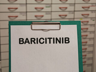 BARICITINIB JAK inhibitor for rheumatoid arthritis alopecia and inflammatory disease displayed on a clipboard in a pharmacy © Semi