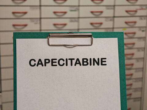 CAPECITABINE antimetabolite chemotherapy for colorectal and breast cancer displayed on a clipboard in a pharmacy