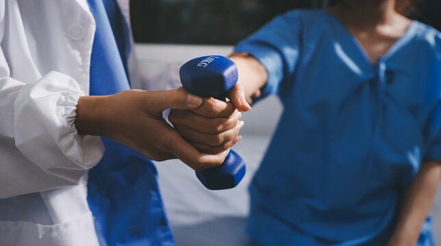Physical therapist giving stretching exercises with elastic exercise bands and physical therapist hands helping male patient Physical therapy concept