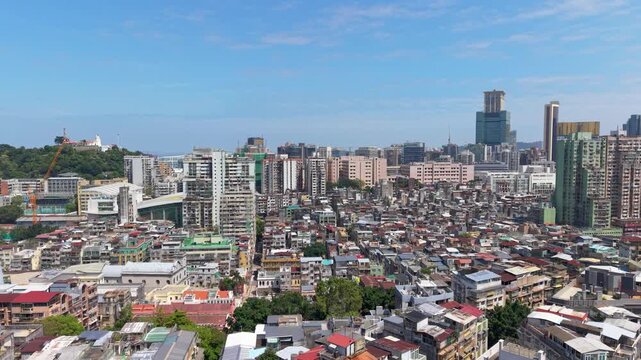 Macau cityscape flight over old town rooftops toward Guia Fortress and Lighthouse hill