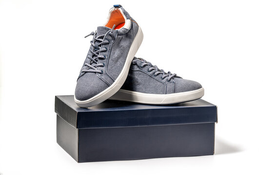 Blue Canvas Sneakers. Sport shoes with a package box isolated on white background, clipping path included