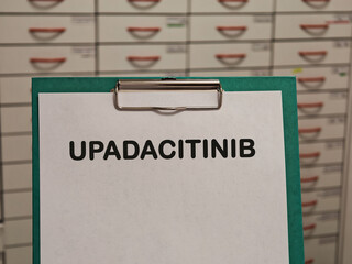 UPADACITINIB JAK inhibitor immunomodulator for rheumatoid arthritis and inflammatory disease displayed on a clipboard in a pharmacy © Semi
