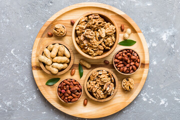 Fototapeta premium Walnut kernel halves, in a wooden bowl. Close-up, from above on colored background. Healthy eating Walnut concept. Super foods with copy space