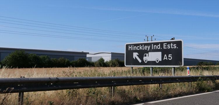 Road sign, Hinckley Industrial Estates, A5, lorry route, UK highway directional signage near warehouses