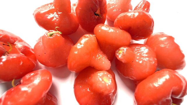 Fresh red rose apples piled on a clean white background studio shot