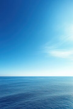 Tranquil open blue ocean beneath a vast clear sky, calm horizon evoking serenity and peaceful solitude