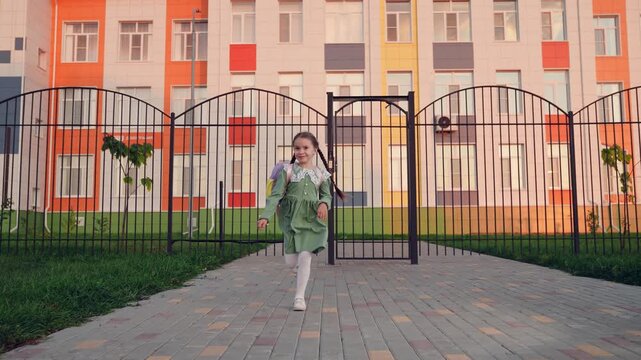 happy man father parent circling child daughter arms. happy family children dream. father meets child from school. child runs against backdrop school building his parents father. man girl happy face.