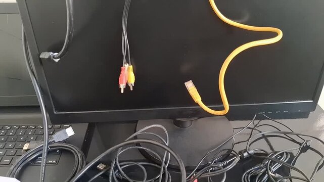 A video showcasing a tangled mess of cables and wires on a desk