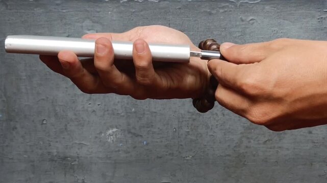 a power bank charging through a USB cable. Portable battery recharging on a table, representing mobile power, technology, and everyday electronic accessories.