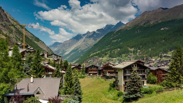 Zermatt Switzerland alpine village timelapse featuring rushing clouds over Swiss Alps mountain valley and chalet architecture