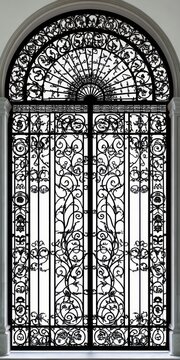 ornate arched wrought iron double gate with intricate scrollwork and floral motifs conveying elegant historic formality